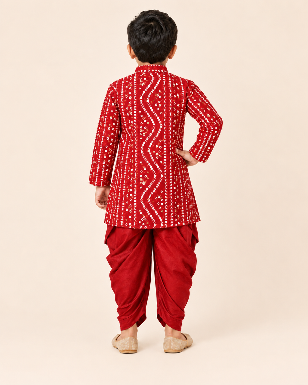 Back view of the boys red bandhani print kurta and draped dhoti set