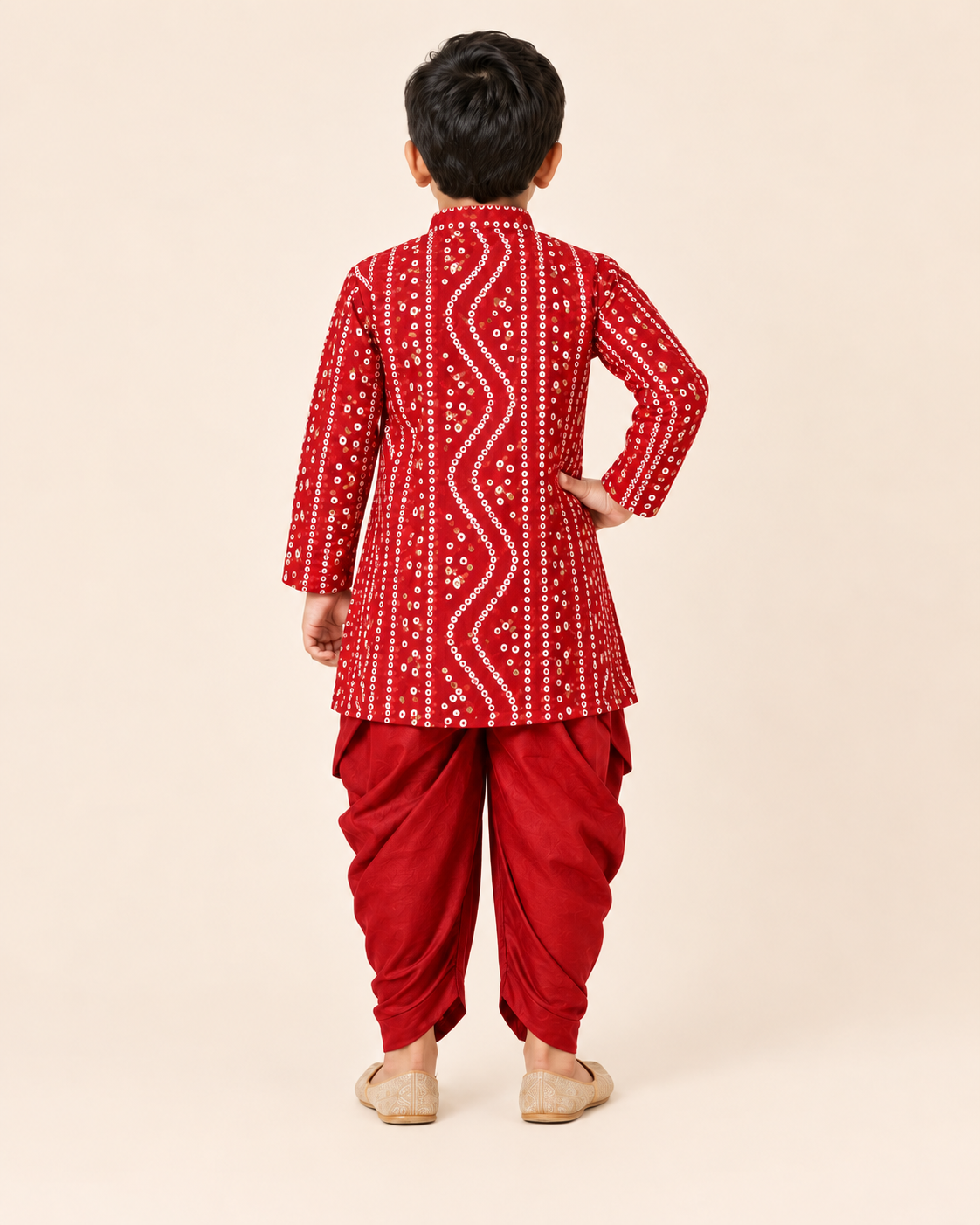Back view of the boys red bandhani print kurta and draped dhoti set