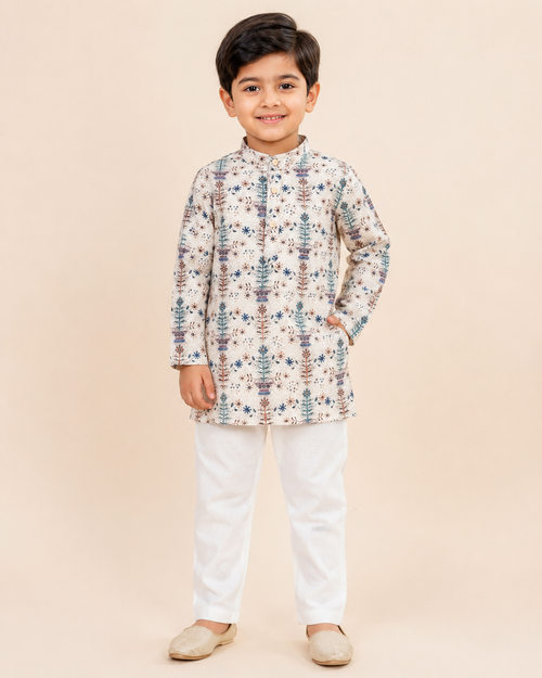 Boy wearing a cream floral print kurta with white pyjama