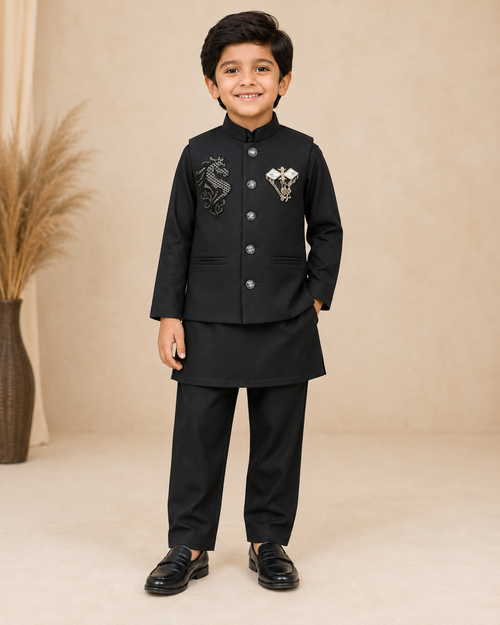 Boy wearing a black embroidered Nehru jacket with brooch over a black kurta and pyjama